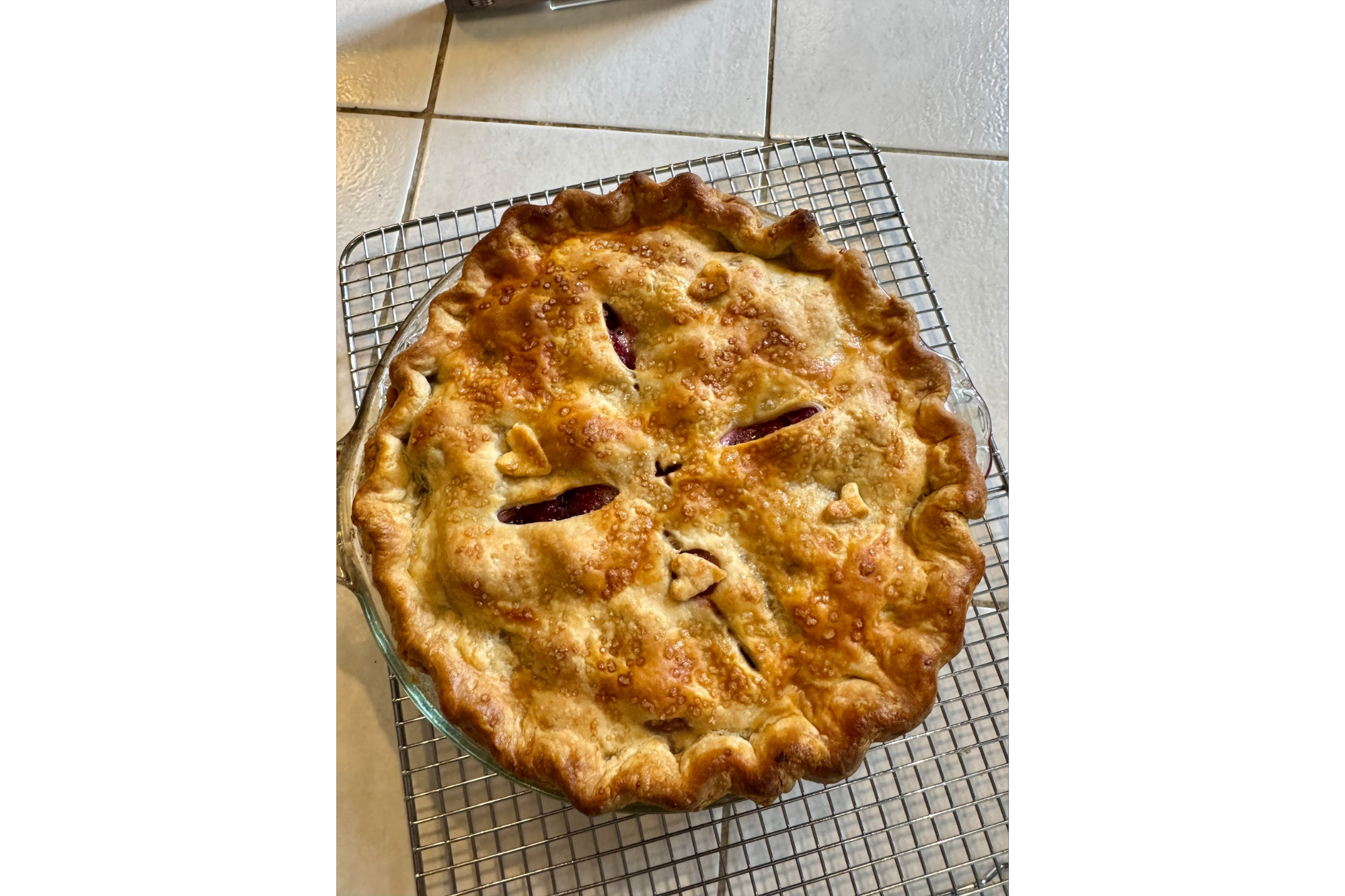 A golden-brown pie with a heart pattern on top of the crust