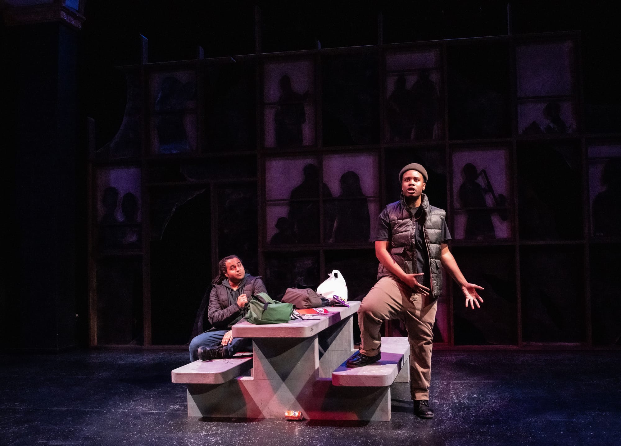 Two men on stage at a concrete picnic table