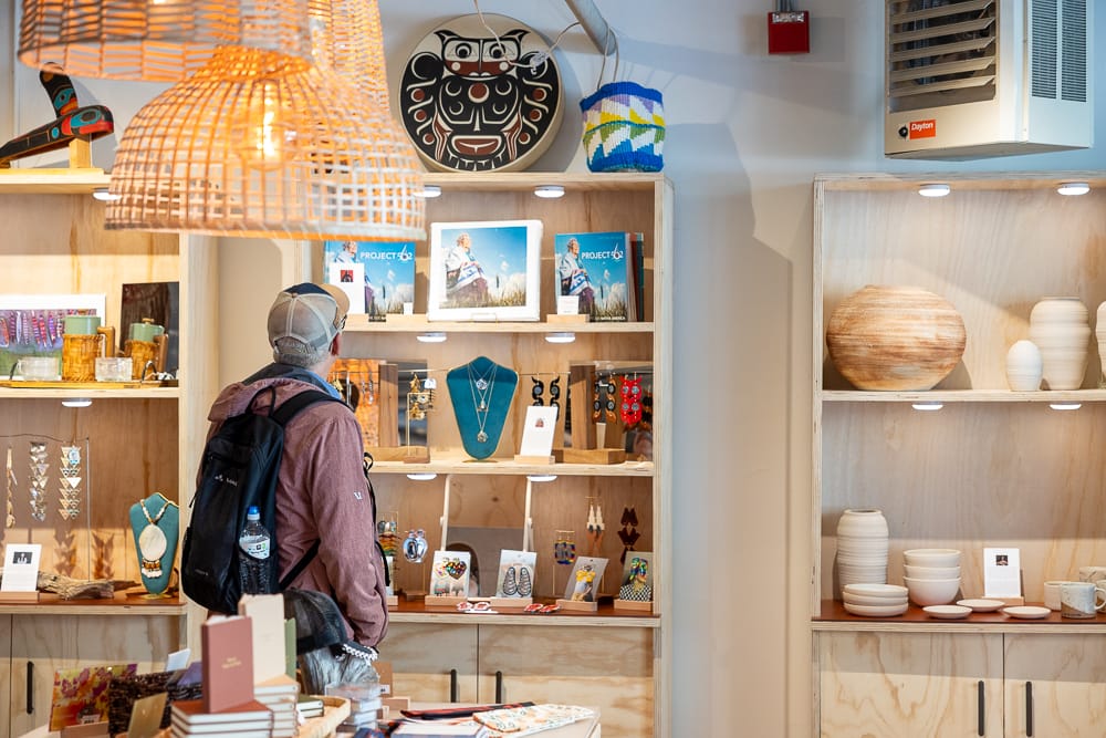 A customer looks at jewelry and photography books on display at the Tidelands boutique
