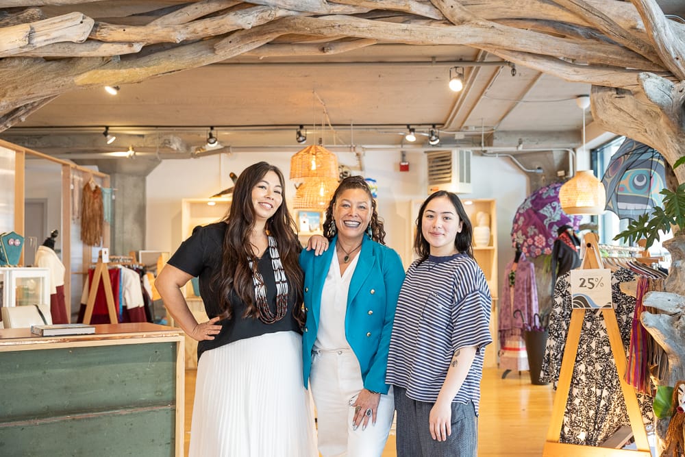 Wilbur and two staff members smile inside the Tidelands boutique