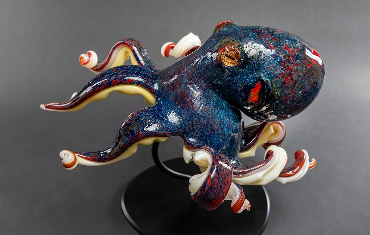 A colorful and realistic octopus formed entirely of glass.