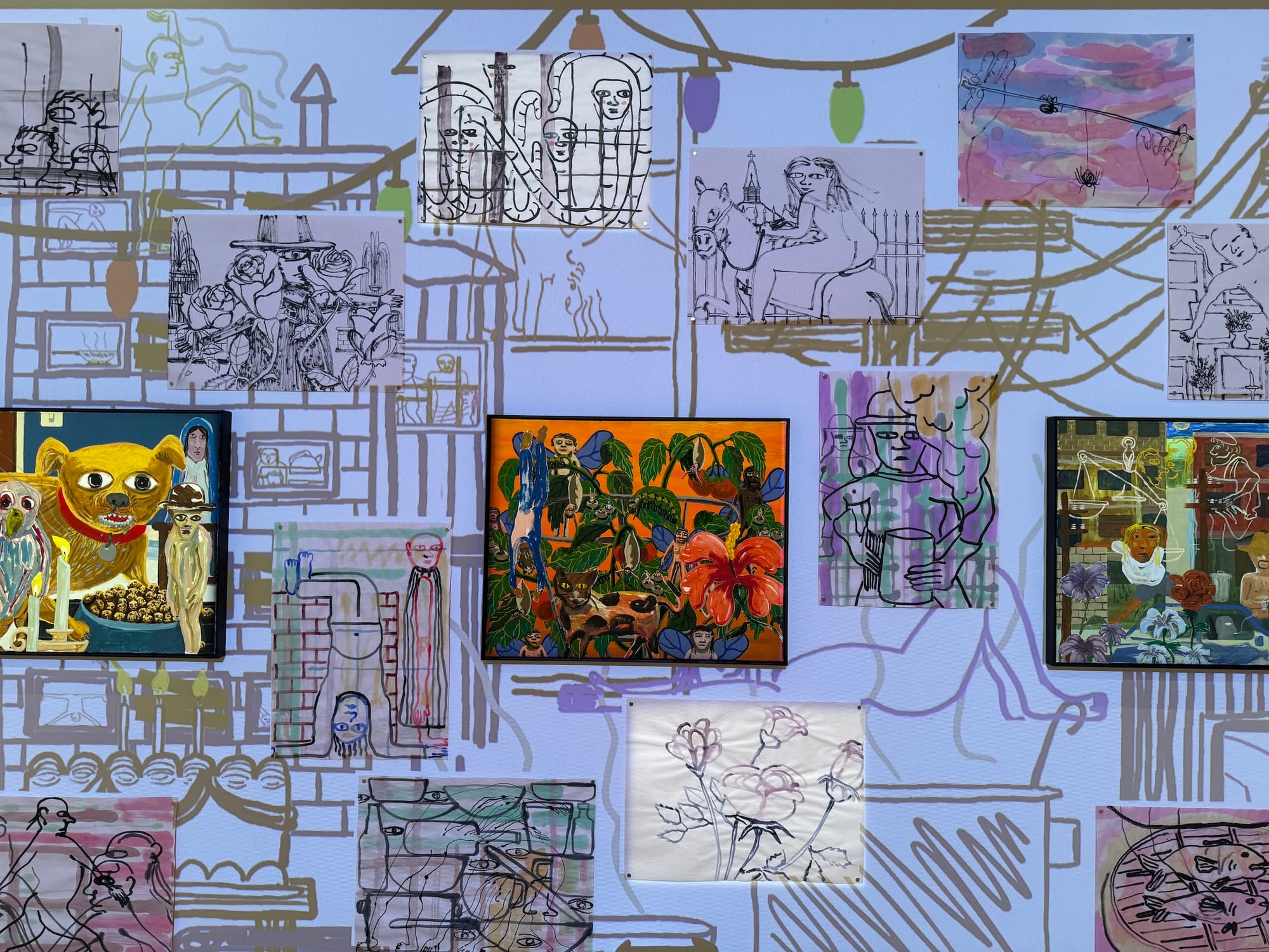 A wall full of loosely drawn and colorful paintings