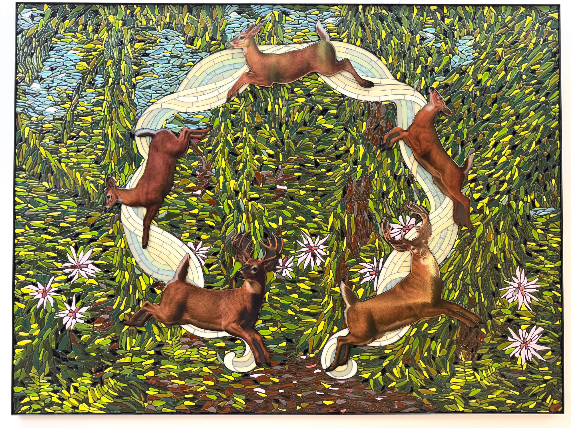 Photo of a mosaic showing a leafy green forest scene with four deer dancing in a circle