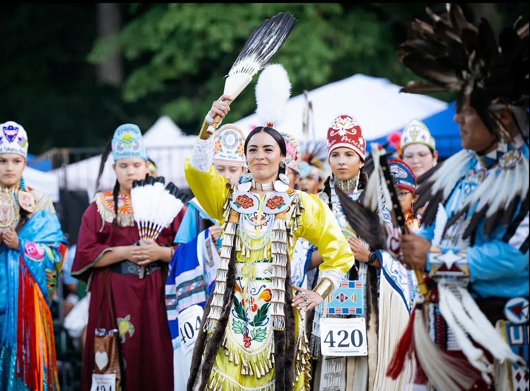 People dance at a powwow gathering