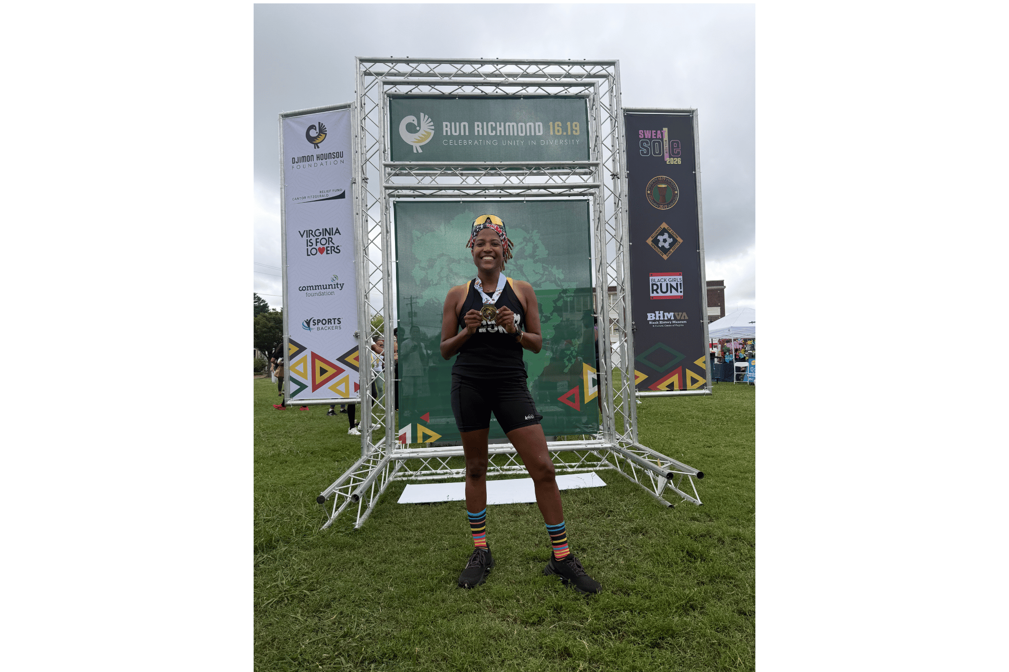 Alison stands at the finish line of a race
