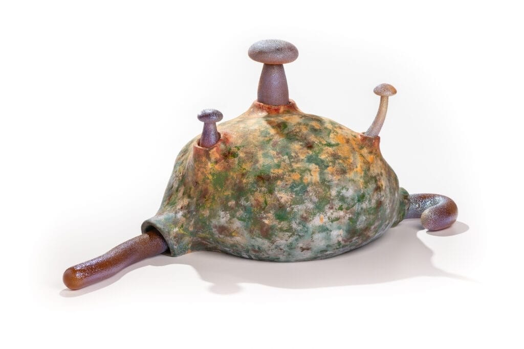 A piece of art made of ceramic and glass that looks like a slug slash mushroom