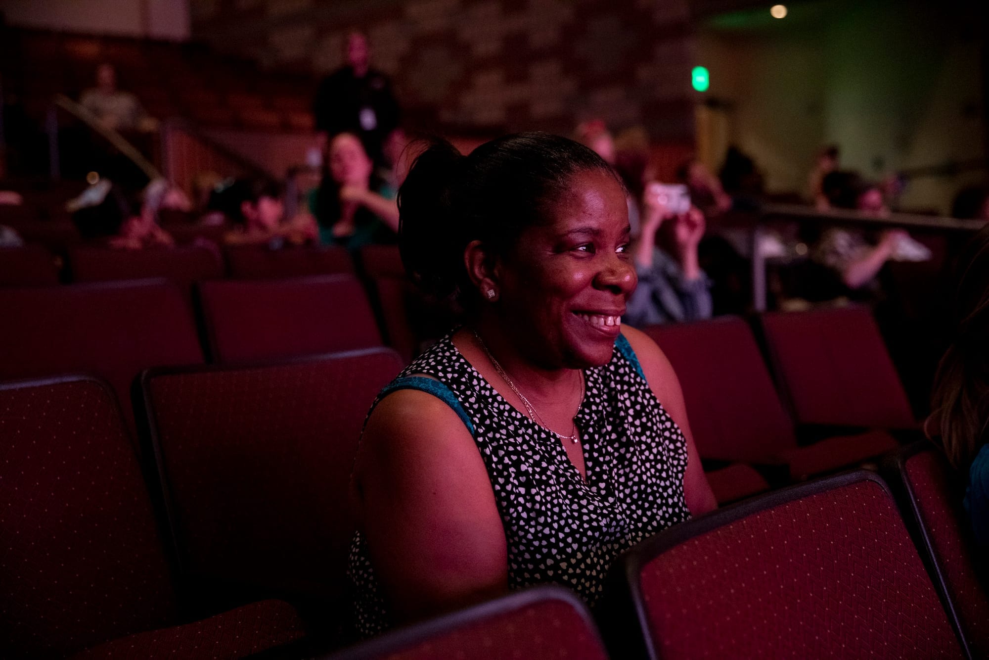 Alesia watches the stage from the audience