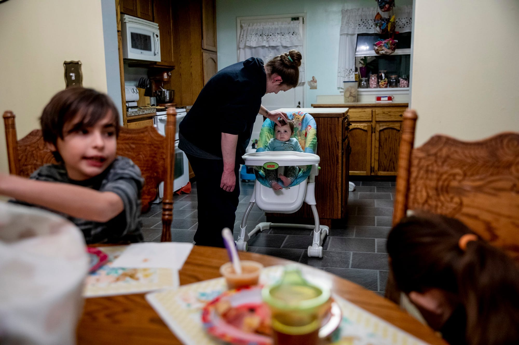 Becca feeds her daughter