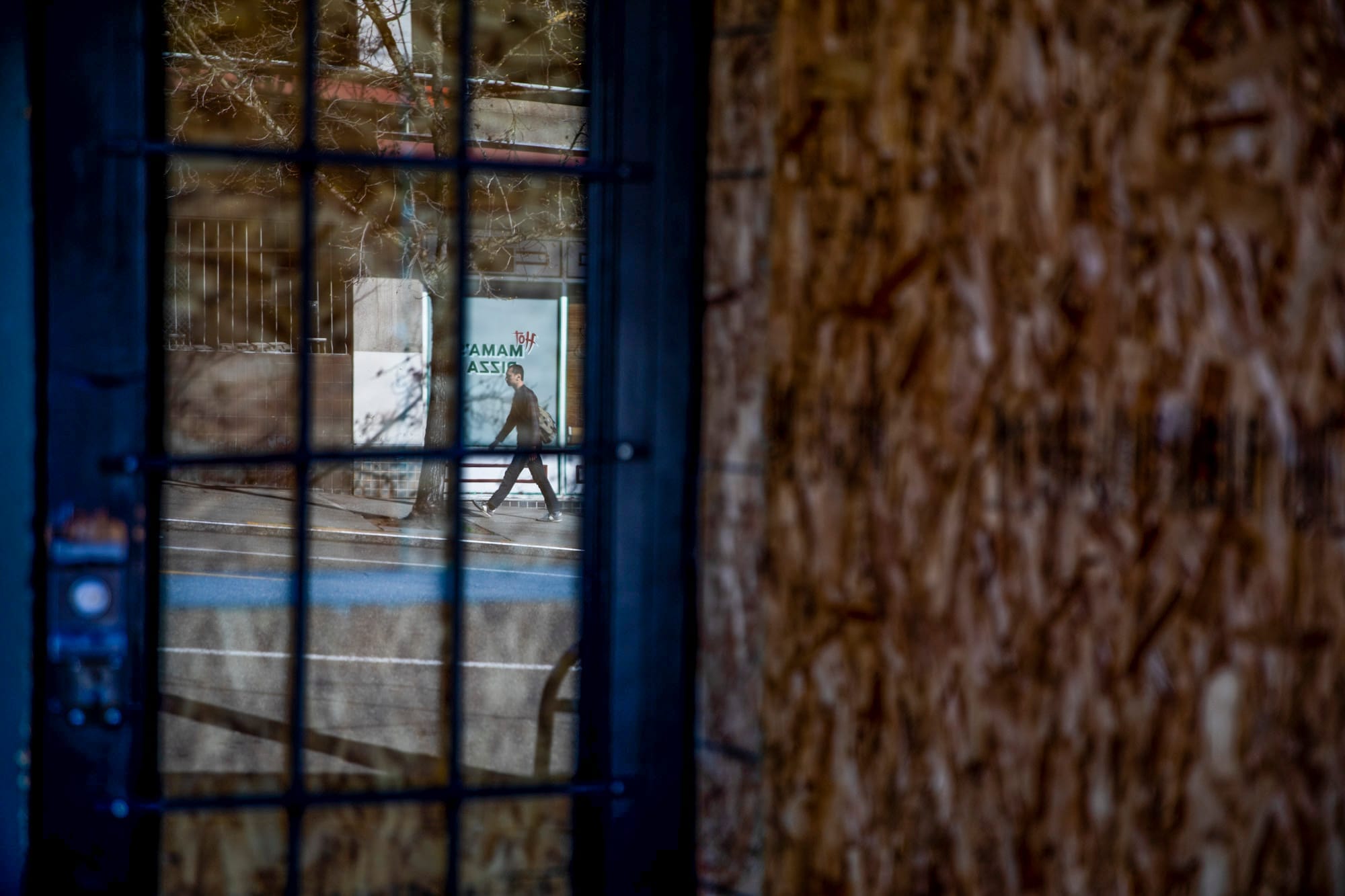 Reflection of man on the sidewalk