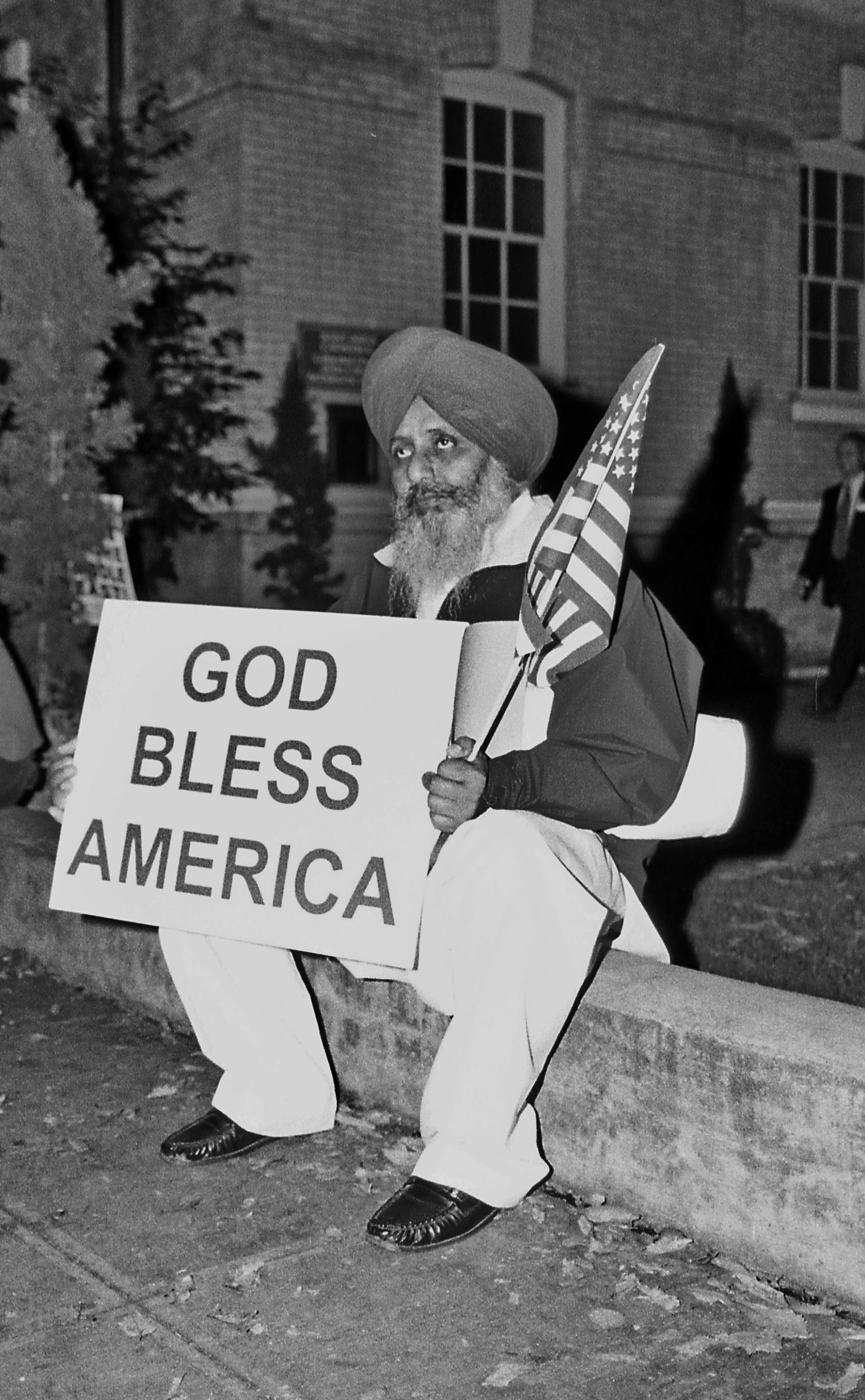 A Sikh man sits in front of Saint James Cathedral at the end of an anti-war march and rally in Seattle during 2003.