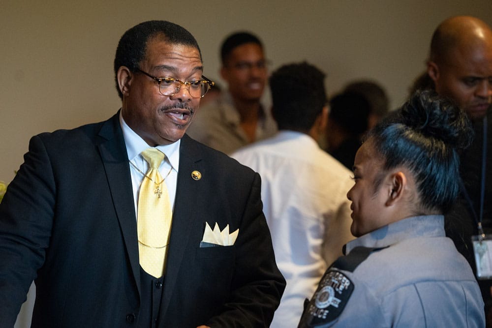 Pastor Kenneth J. Ransfer speaks to a young office-in-training at the swearing in cereomony for Chief Carmen Best.