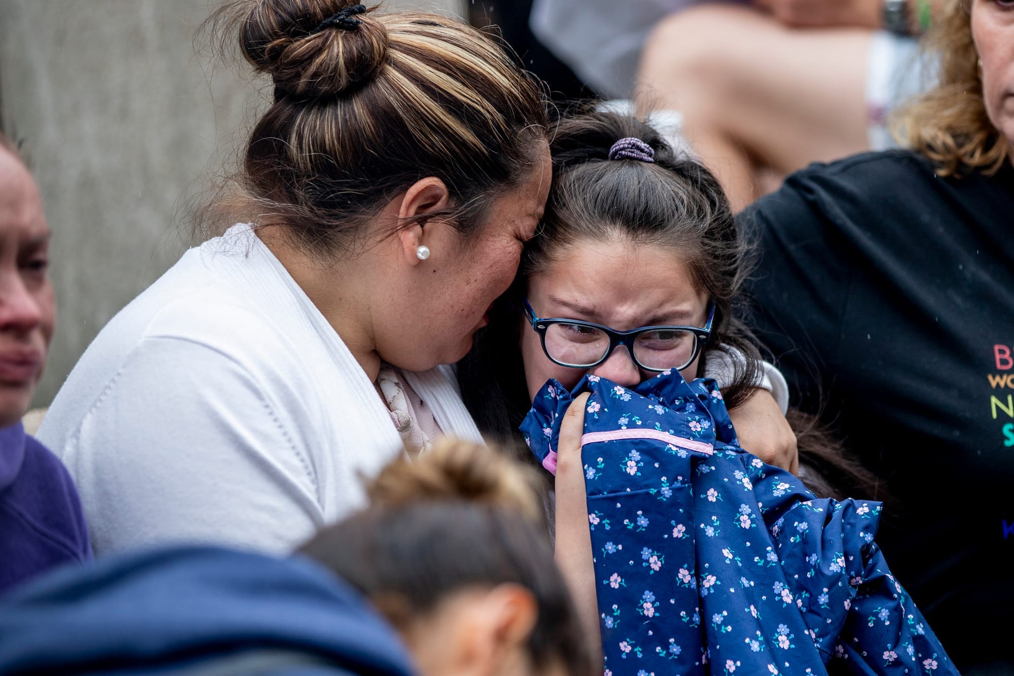 Jose Robles’ wife and daughter, Natalie, 9, embrace as they learn that Robles had been detained by ICE in Tukwila on July 17, 2019. Robles went to the ICE offices to request a stay of removal but was arrested instead. (Photo by Dorothy Edwards/Crosscut)