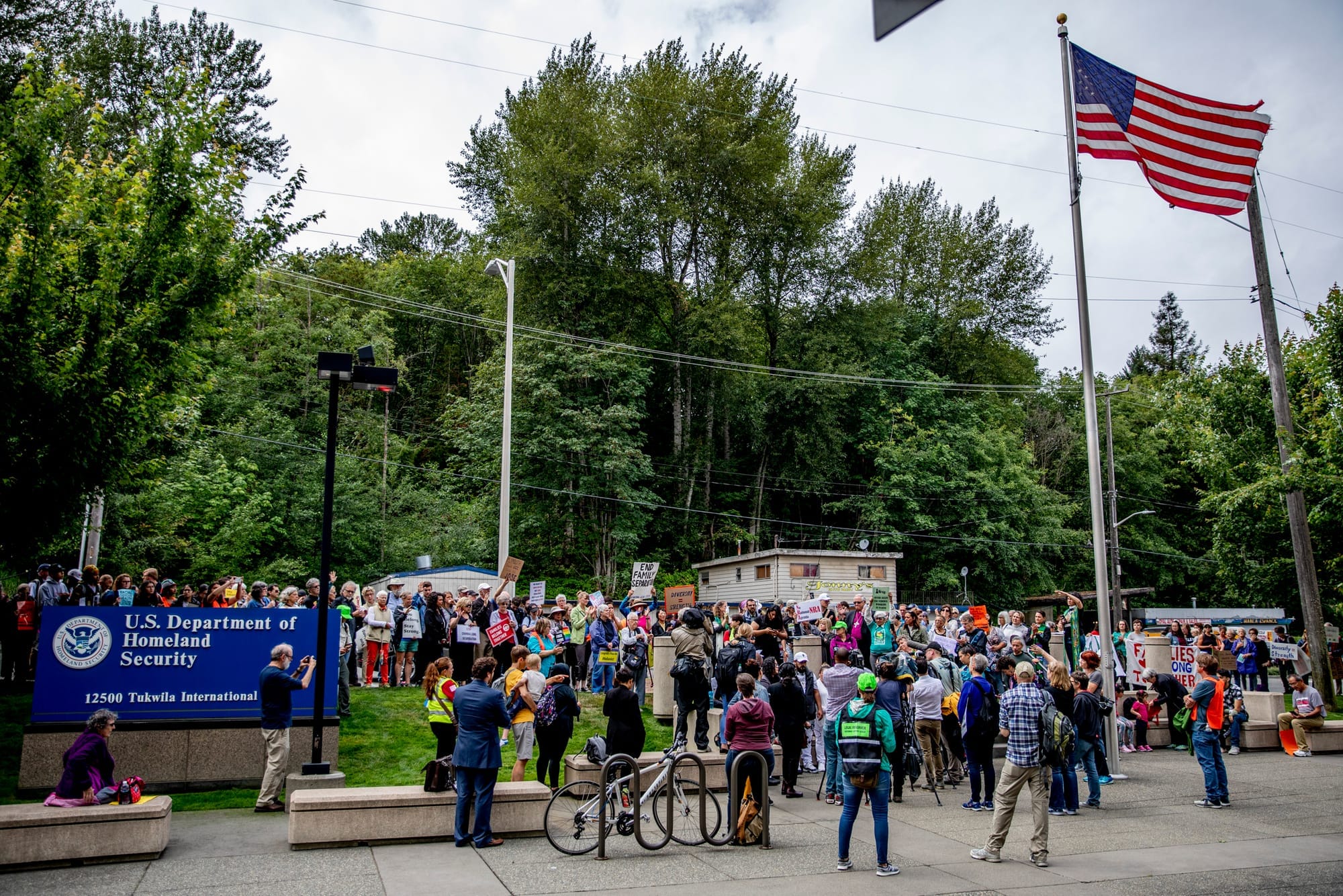 Community members and activists rally around Jose Robles outside of the ICE offices in Tukwila on July 17, 2019. The undocumented father of three requested a stay of removal but was arrested instead. (Photo by Dorothy Edwards/Crosscut)