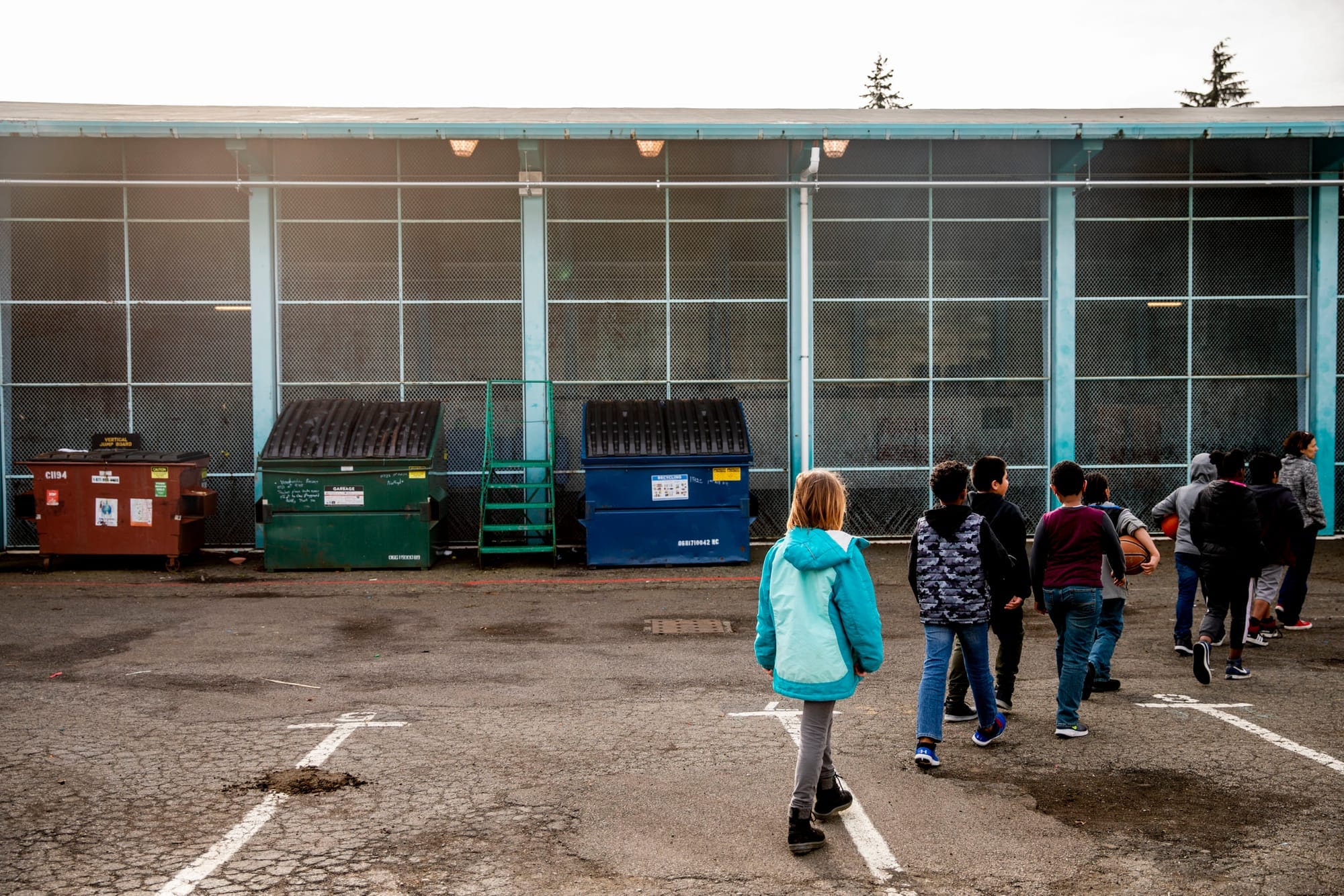 Students line up on the playground at the end of recess at Northgate Elementary School on , Jan. 31, 2018. Lack of space has forced students to share their concrete playground with Dumpsters.