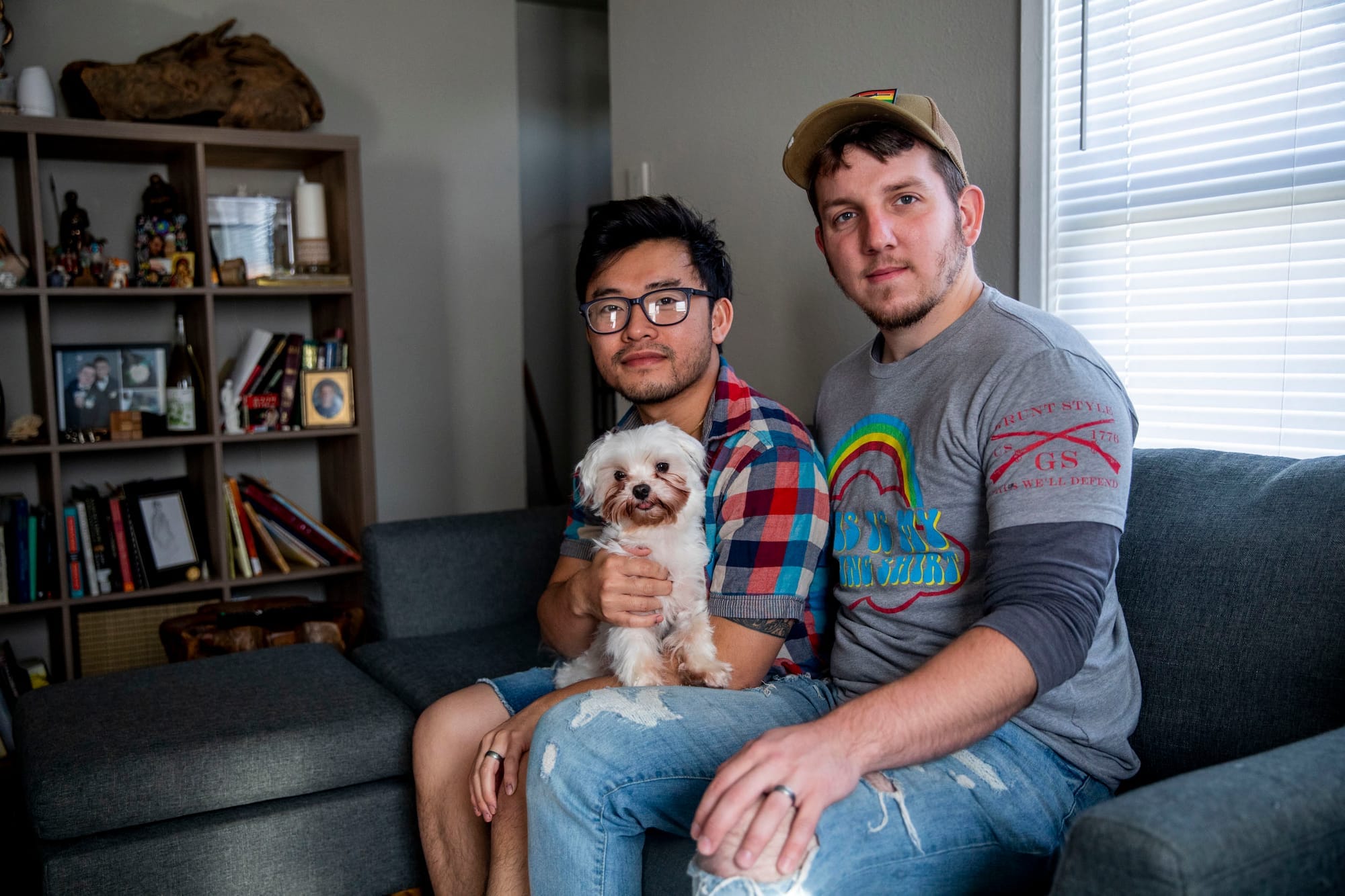 Pink Pistols administrator John Abbitt, right, and his husband Victor Chu in their Tacoma home on May 18, 2019. Though Chu is less involved with Pink Pistols than his husband and didn’t grow up with guns, he now owns his own rifle. He attributes his attitude change towards guns to his husband. “Once I took a step back, I had to take a look at the intentions. Like for John, his involvement in Pink Pistols, it’s more focused on empowering people - and let’s face it, a lot of times the LGBTQ community feels powerless in certain situations, or threatened, or at risk. They don’t feel safe,” Chu says.(Photo by Dorothy Edwards/Crosscut)