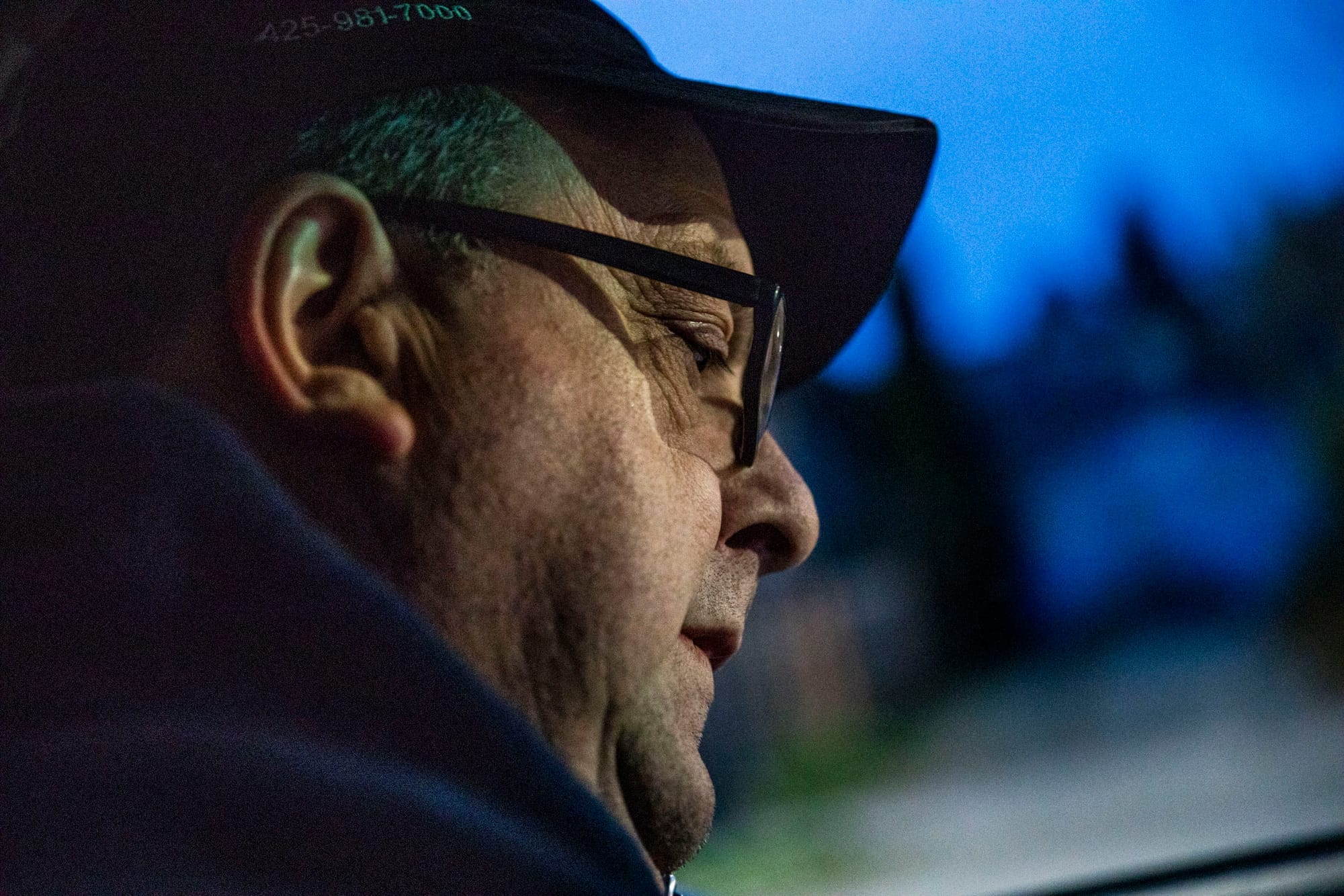 Doug Latta, 58, checks his route list in his car during his final delivery route for the Seattle Weekly on Feb. 27, 2019. (Photo by Dorothy Edwards/Crosscut)