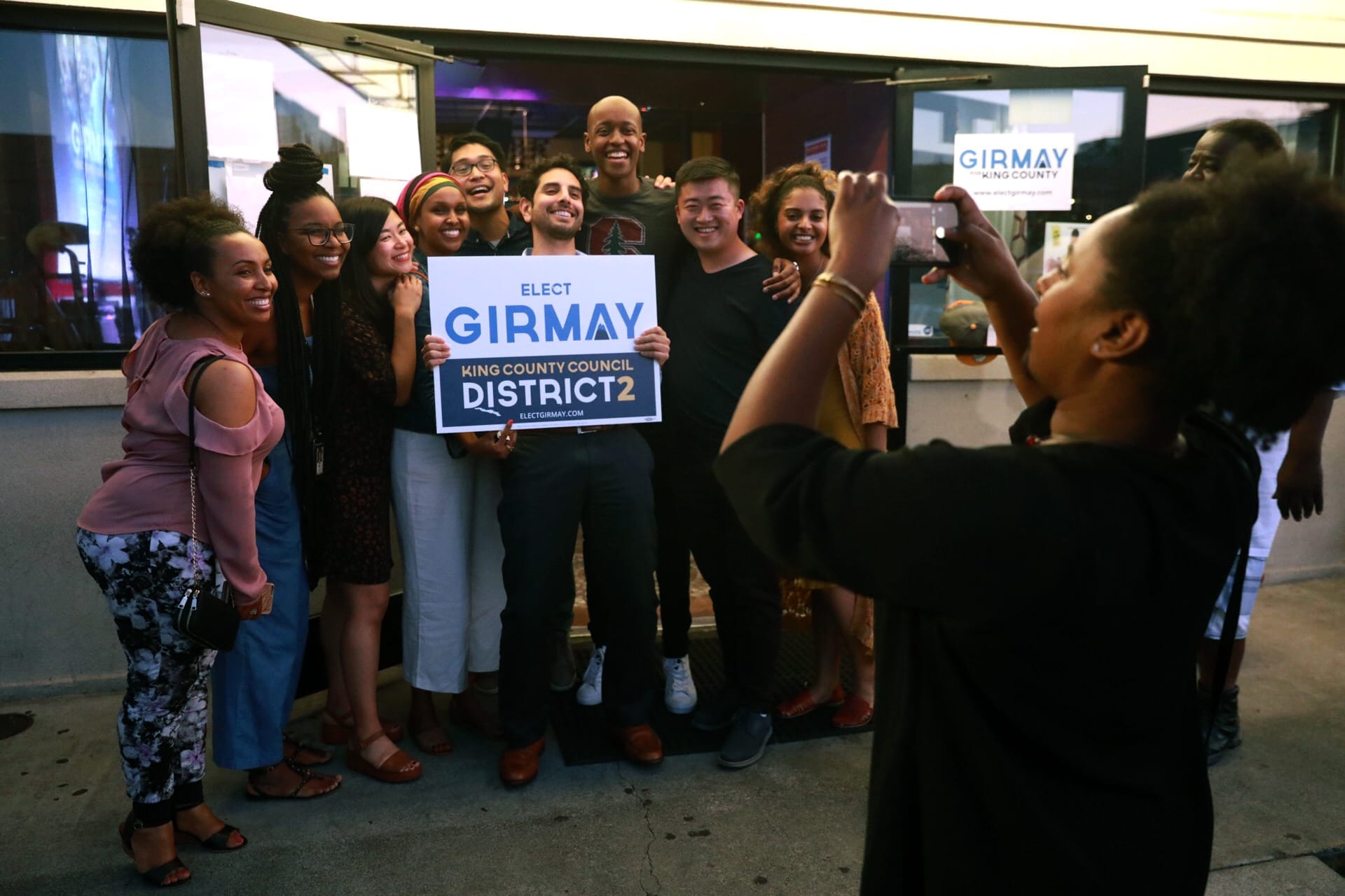 Girmay Zahilay poses with supporters.