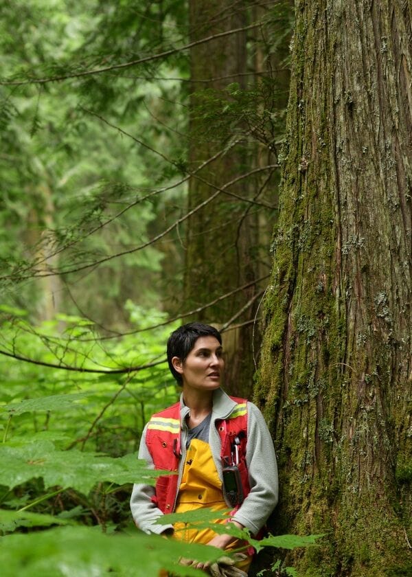 Michelle Connolly of Conservation North stands in a forest