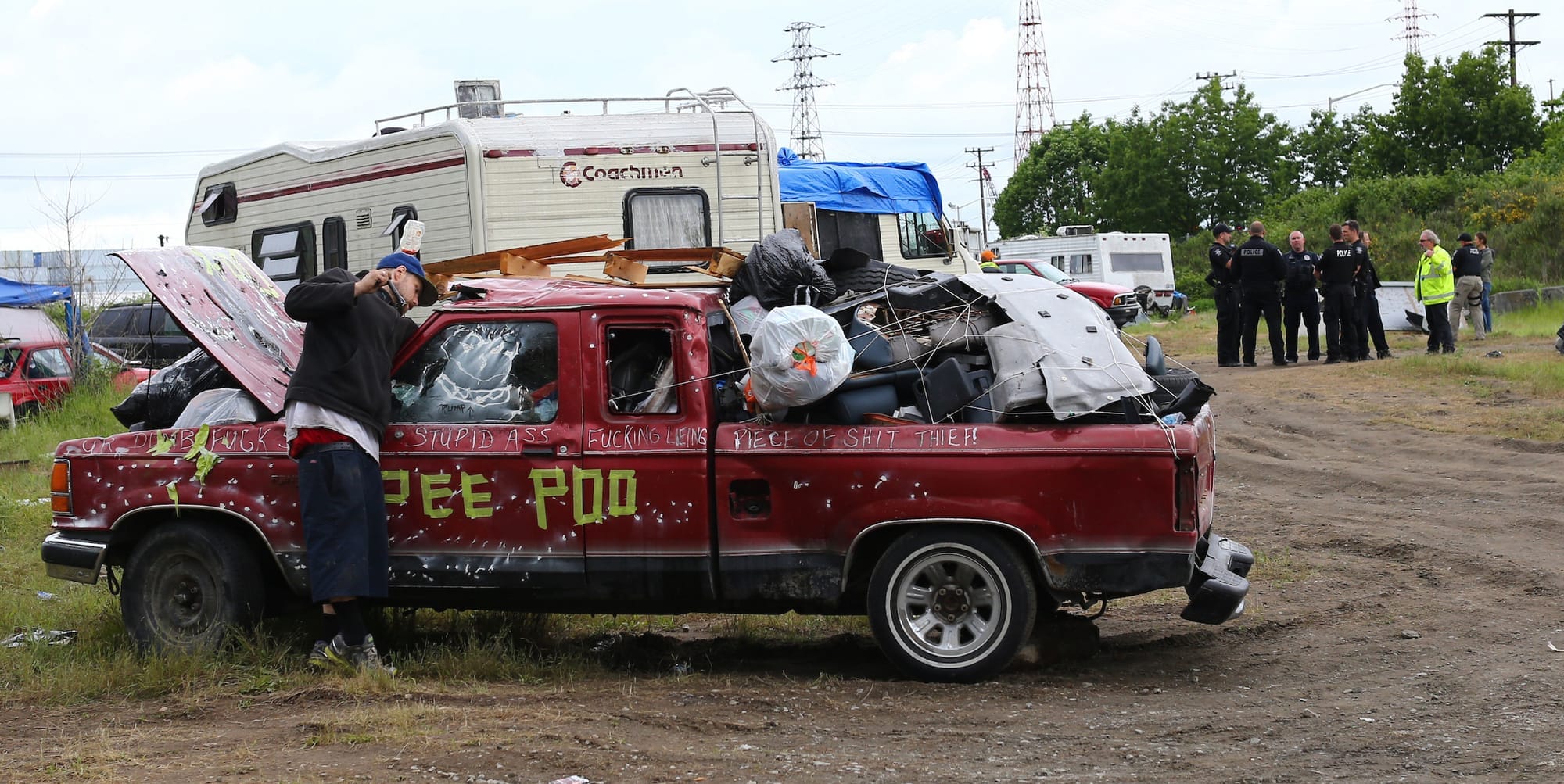 Man packing his belongings in an old pickup truck