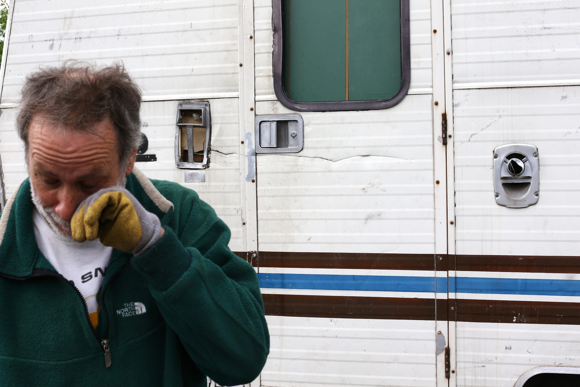 Man crying in front of a trailer