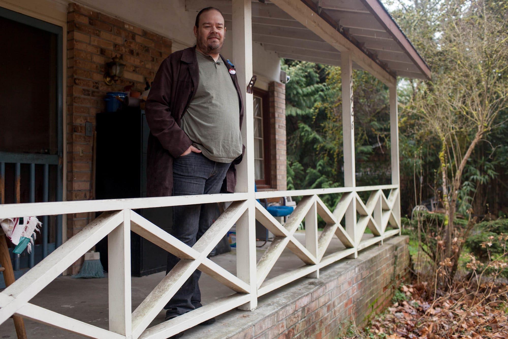 John Novak standing on the front porch of his home.