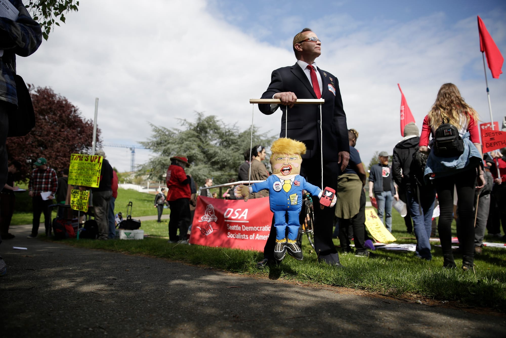 Eric Zorrozua of Bremerton, Wash. dressed as Russian President Vladimir Putin holds a puppet of President Donald Trump during the annual May Day March for Workers and Immigrant Rights in Seattle
