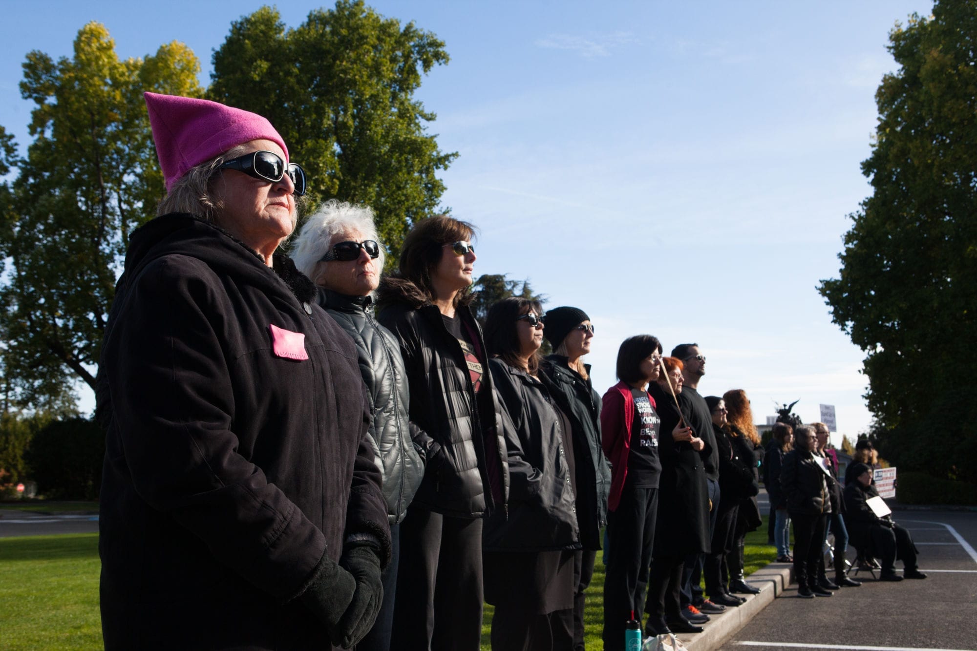 Marilyn Richer of Olympia wears a pink pussy hat as she watches the handmaids stand in silence.