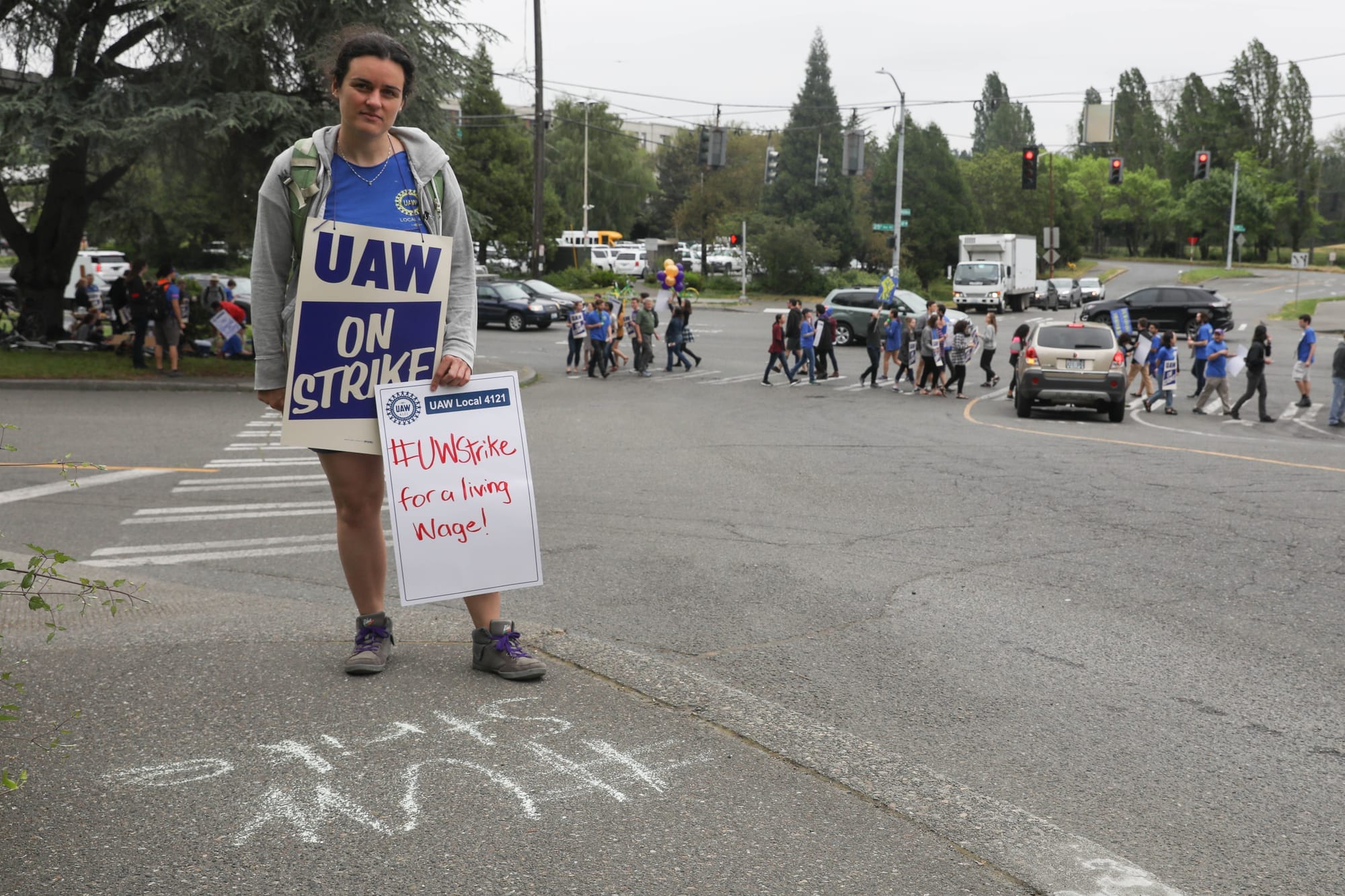 Emily Willard stands near the corner of Pend Oreille Street and Montlake Boulevard NE during a one-day strike with graduate students who are represented by UAW Local 421 at the University of Washington in Seattle, May 14, 2018.