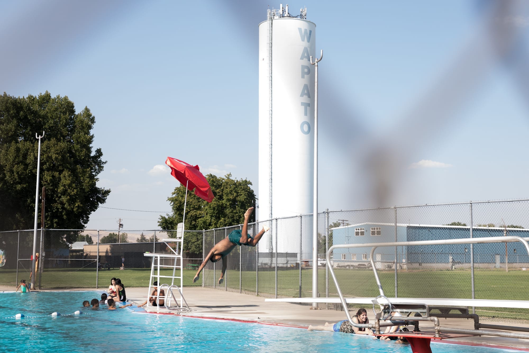 Child diving into swimming pool