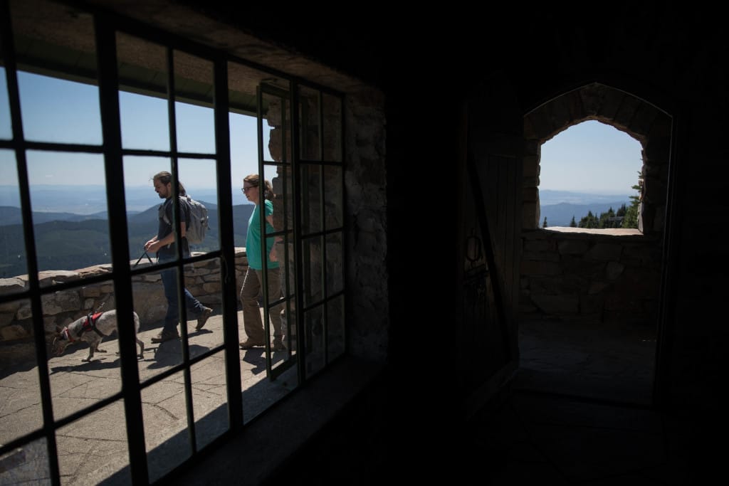Visitors walk outside Vista House at the top of Mt. Spokane State Park