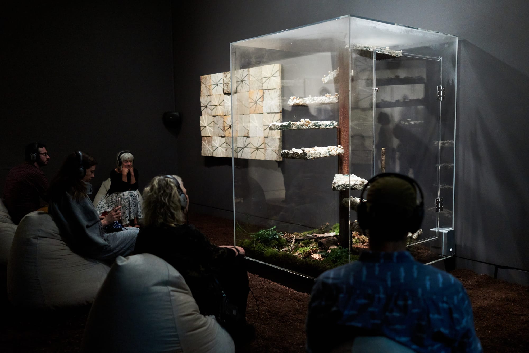 Frye Art Museum visitors spending time with Marcos Lutyens’ “Library of Babel, a Symbiont Induction” PHOTO CREDIT: Jonathan Vanderweit