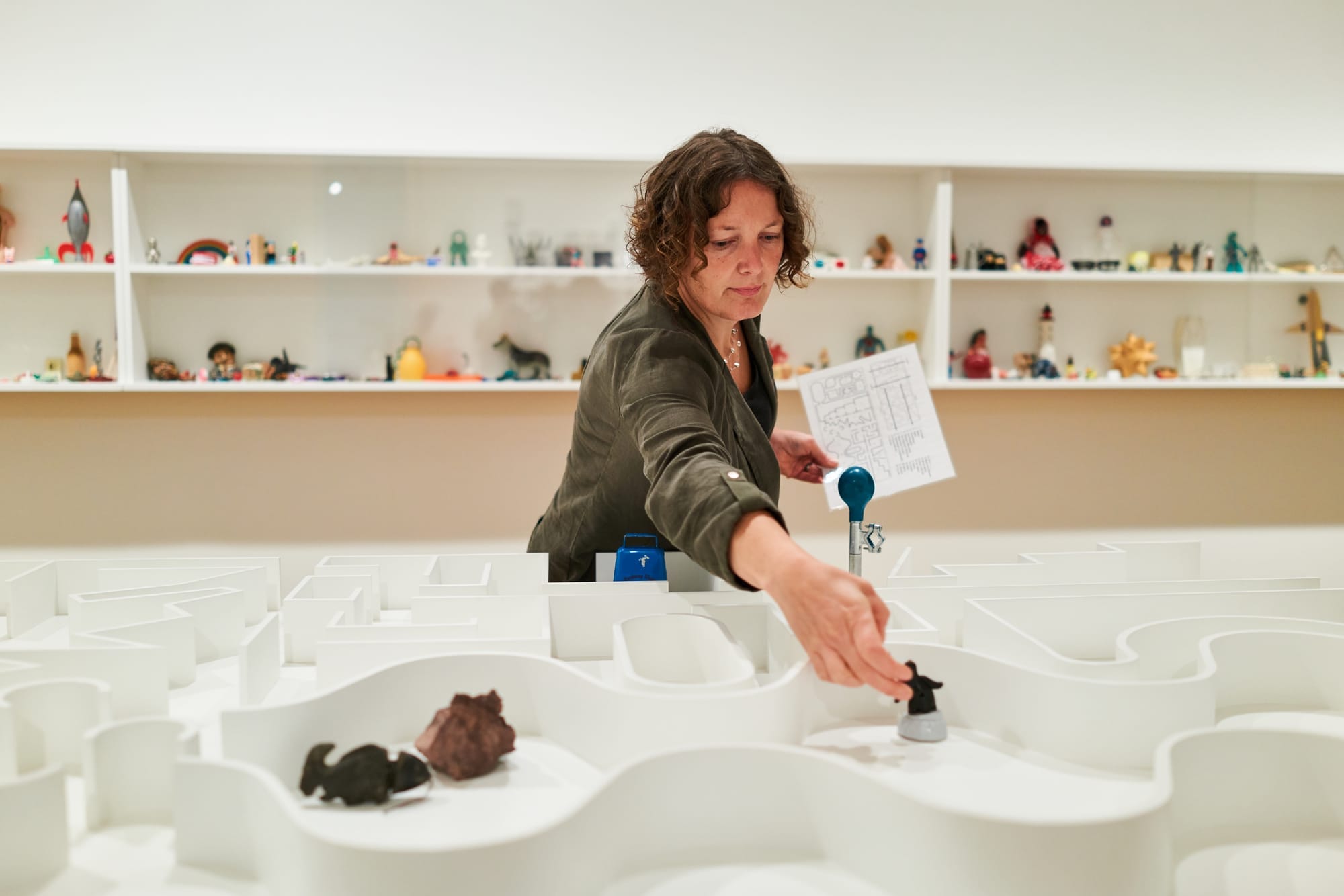 A Frye Art Museum visitor interacting with Pedro Reyes’ “The Museum of Hypothetical Lifetimes” PHOTO CREDIT: Jonathan Vanderweit