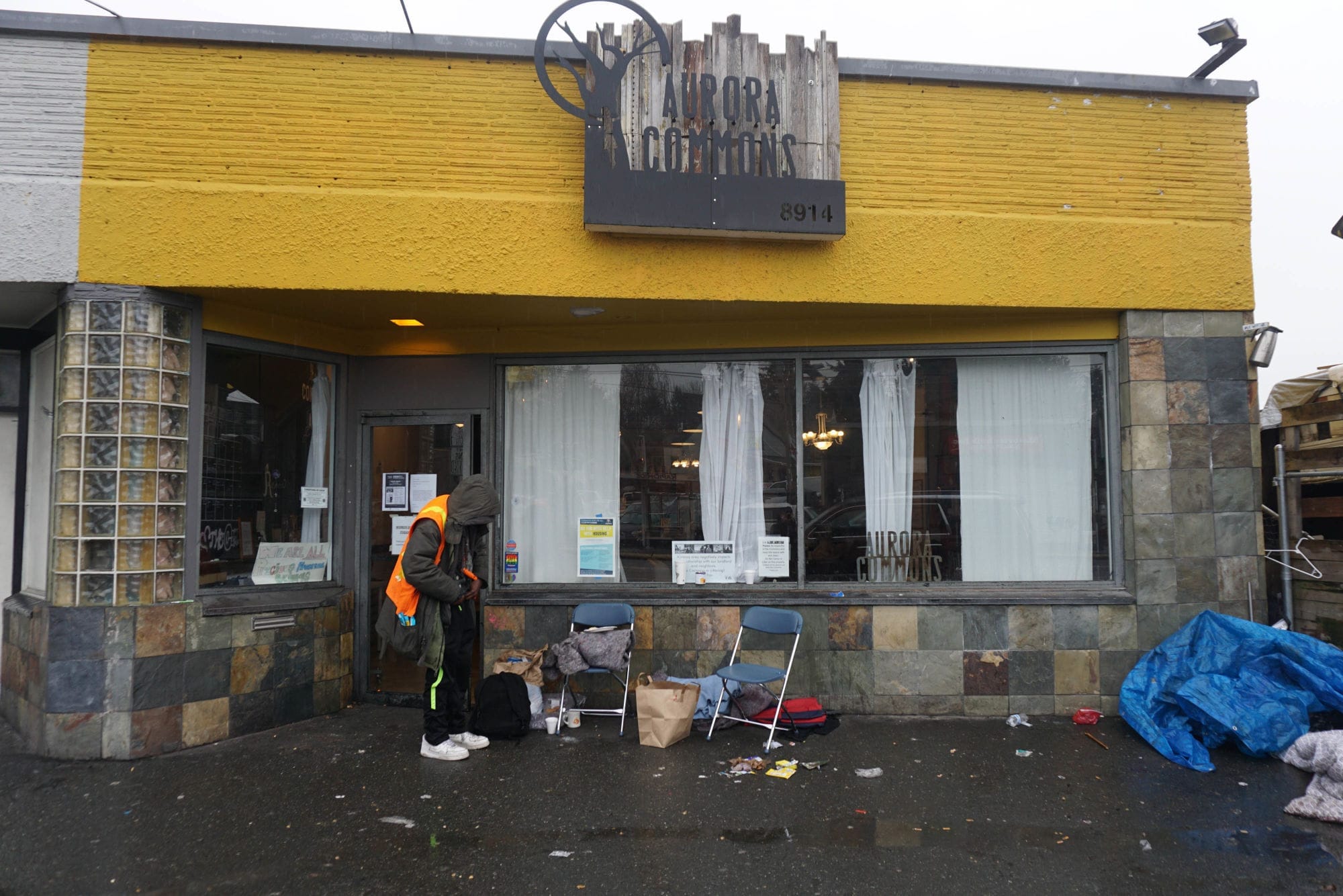 A person in front of Aurora Commons