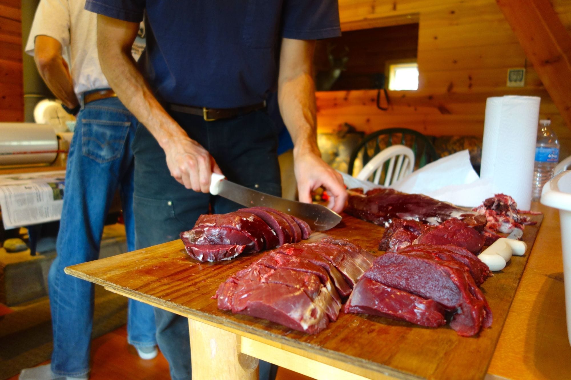 Deer meat being carved indoors