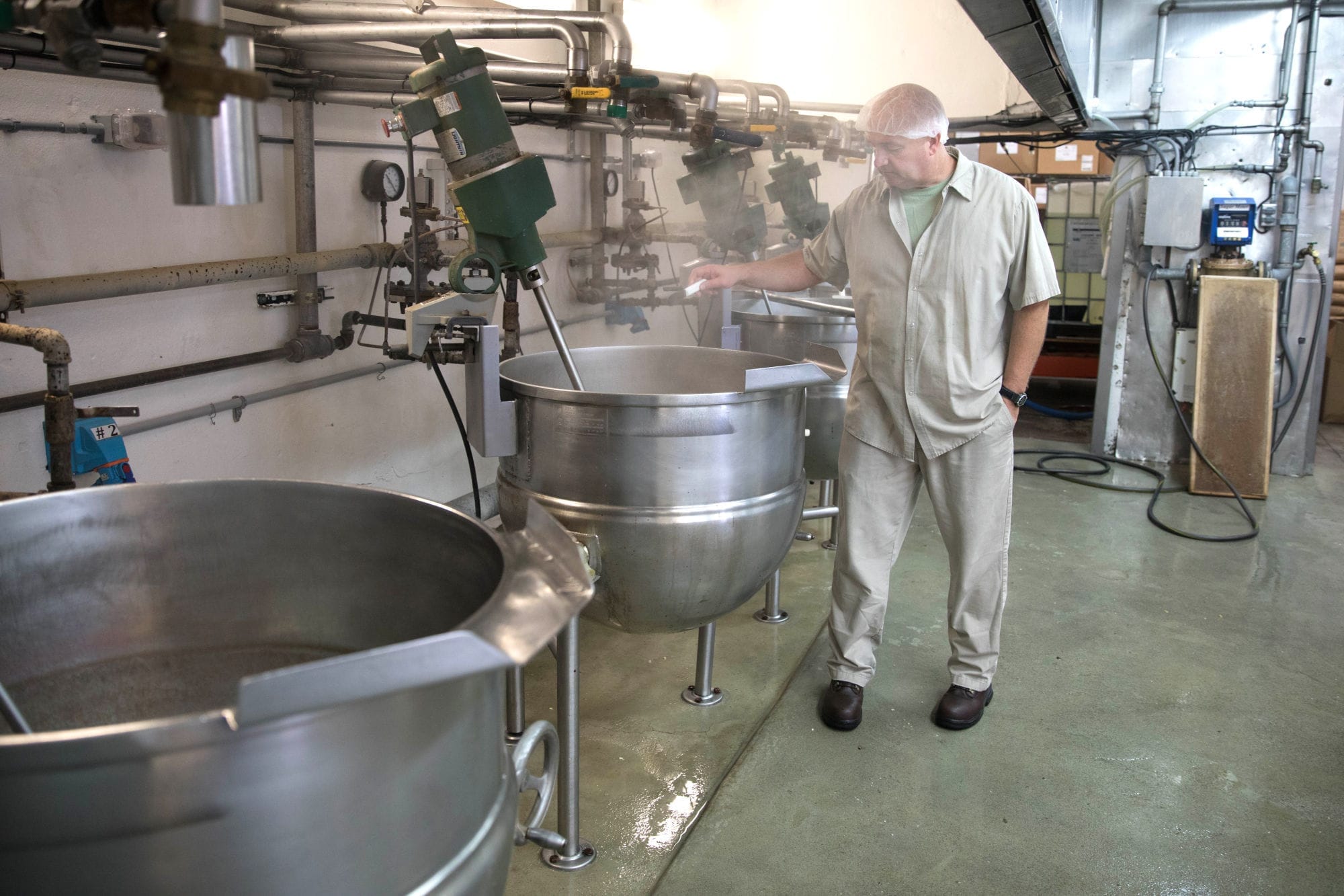 An employee in the kitchen at the Liberty Orchards candy factory.