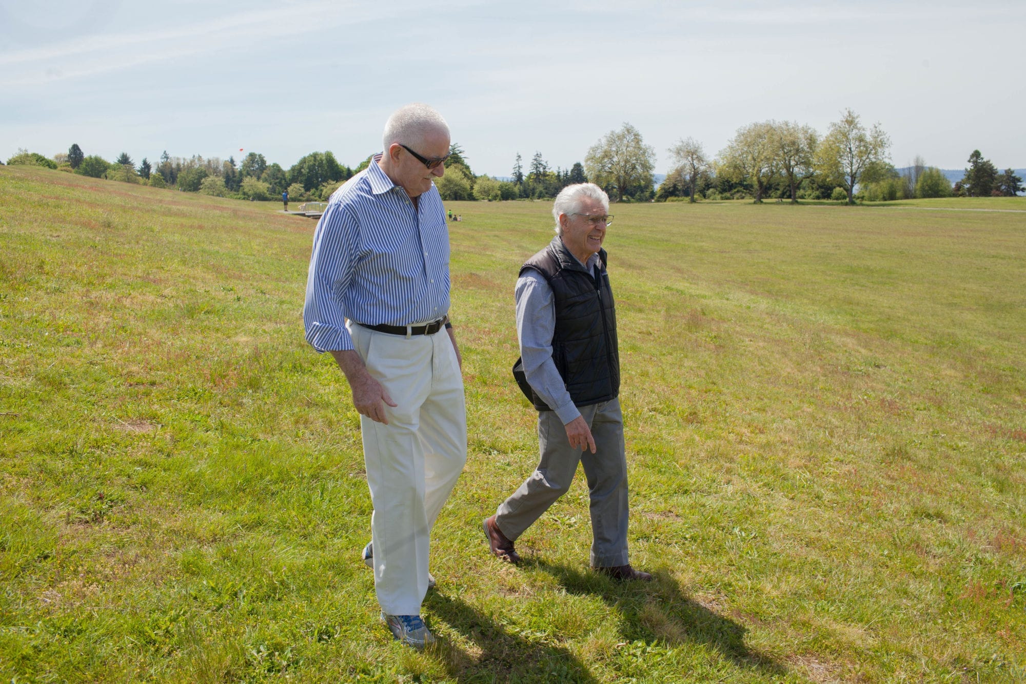 Former Mayor Wes Uhlman and landscape architect Peter Ker Walker stroll through Discovery Park