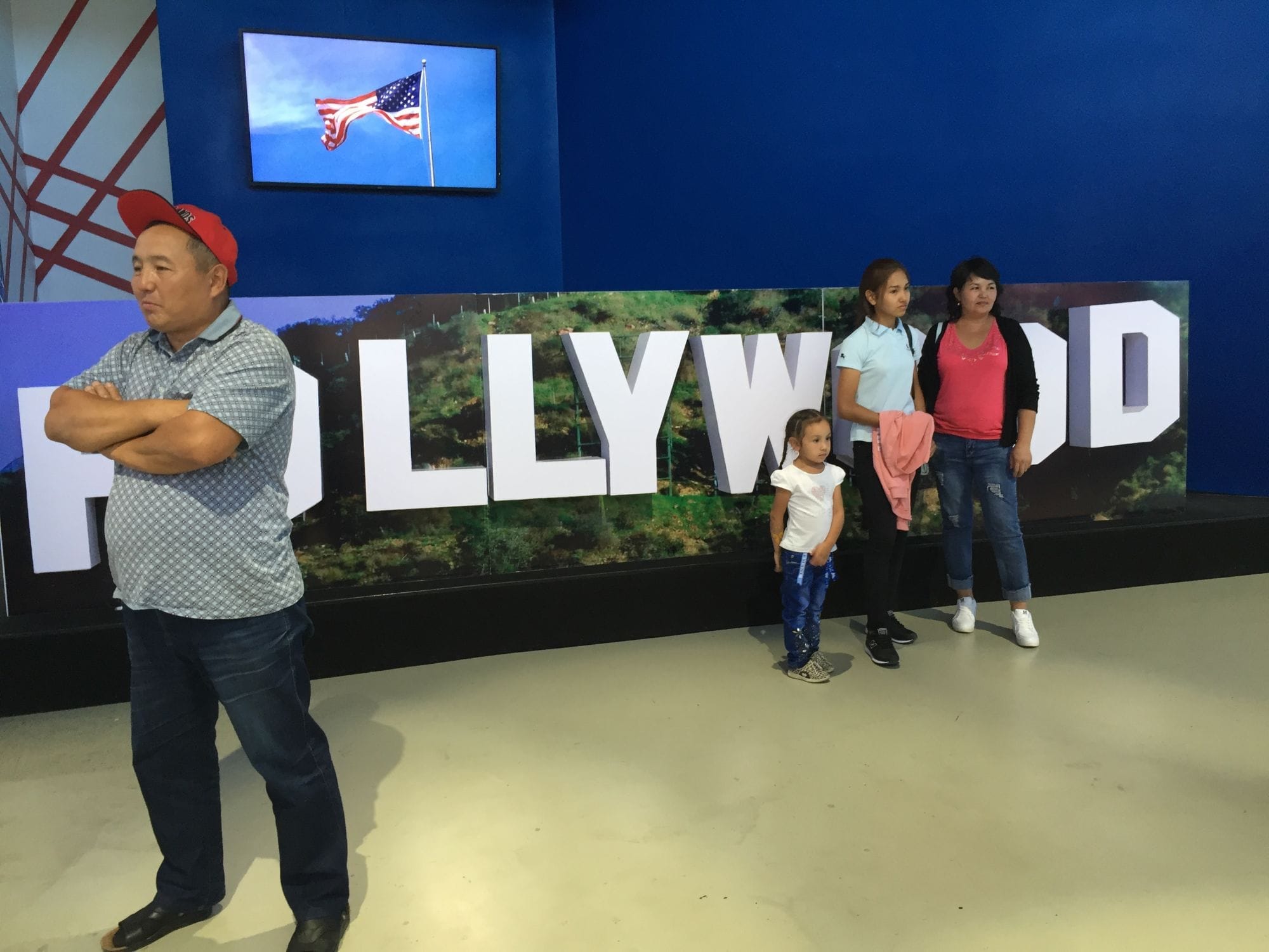 People taking picture in front of the Hollywood sign