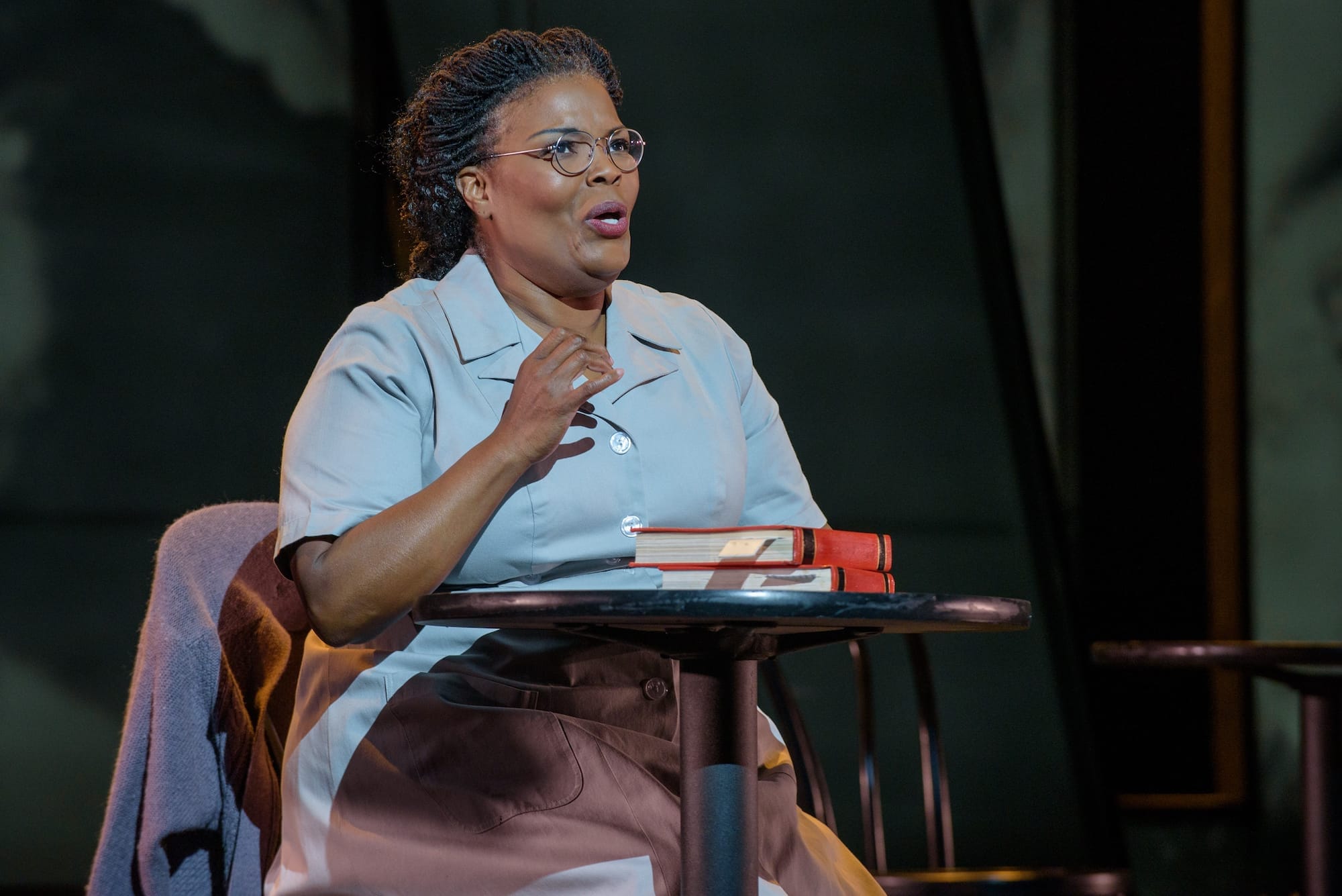 a woman on stage in glasses