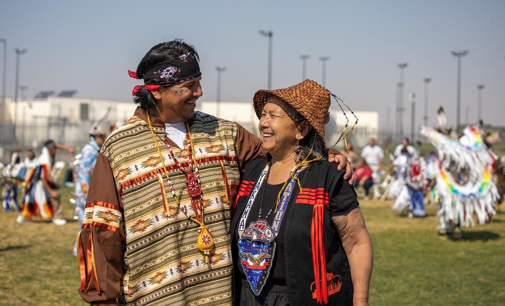 Tallon Saluskin smiles and wraps an arm around his mother, Edith Marie John