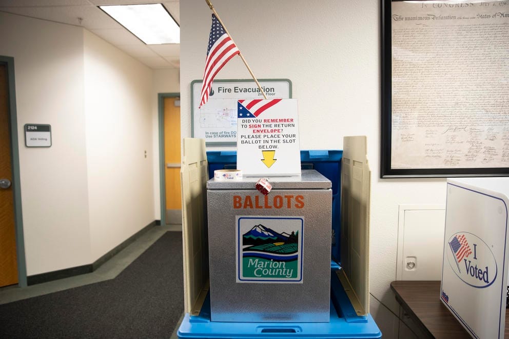Ballot box with a sign on top that reads