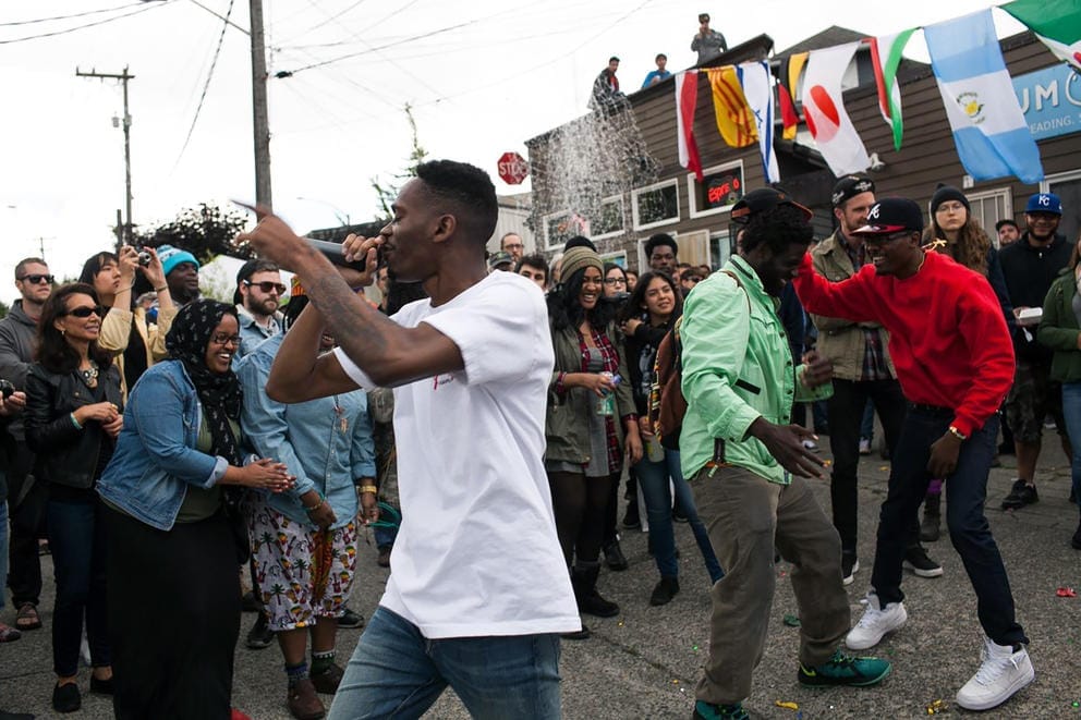 A young man holds a microphone during an outdoor performance