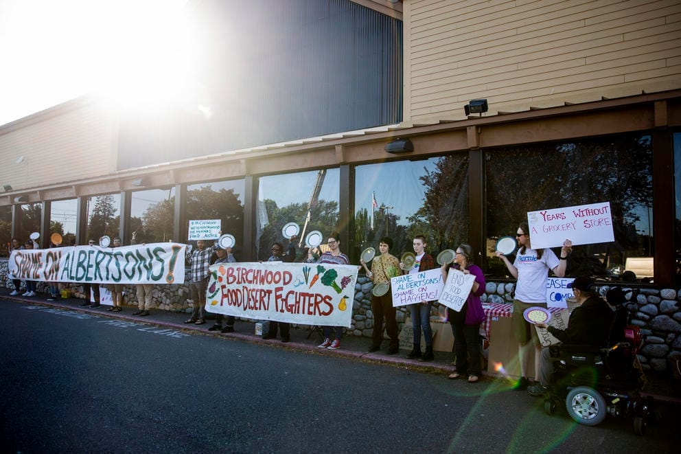 A rally outside of a closed grocery store