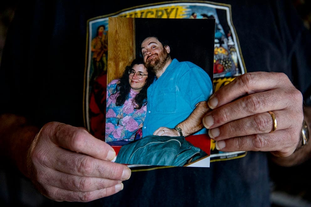 Eric holds a photo