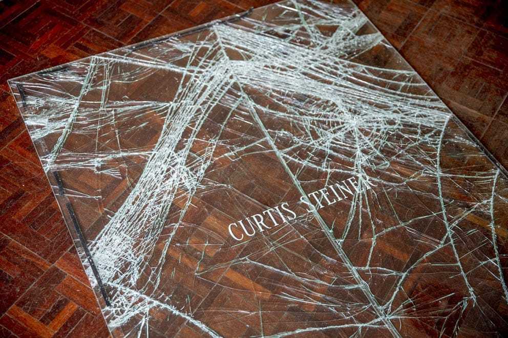 Shattered glass against wood floor.