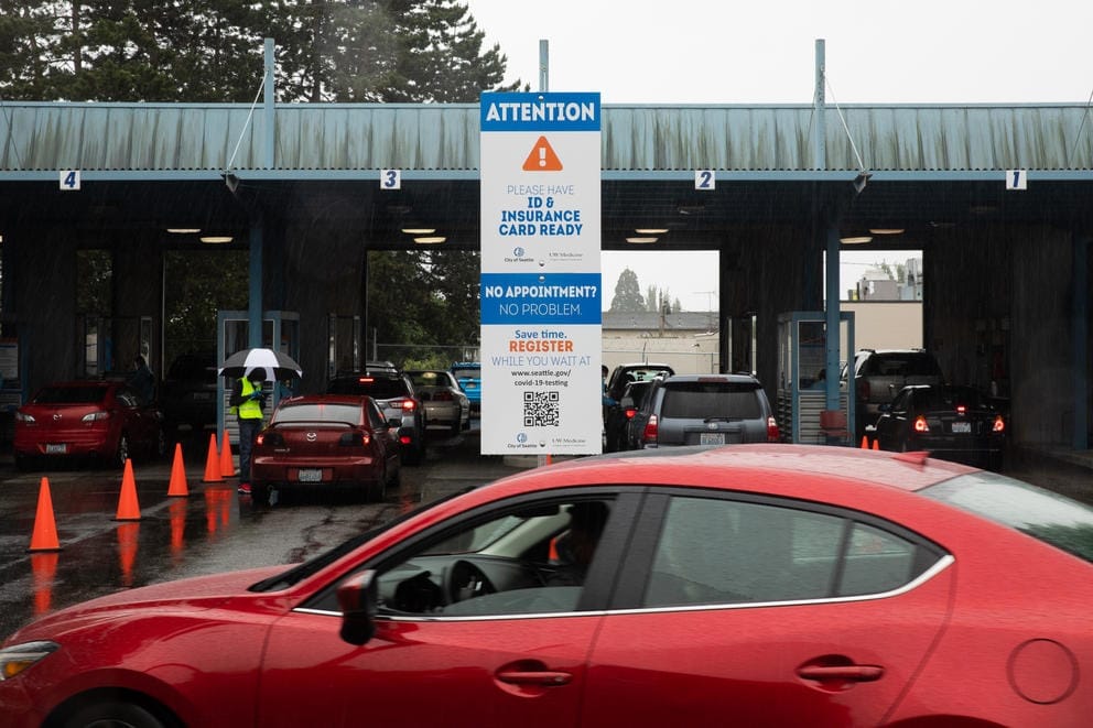 Vehicles pull into a drive-up COVID-19 testing facility