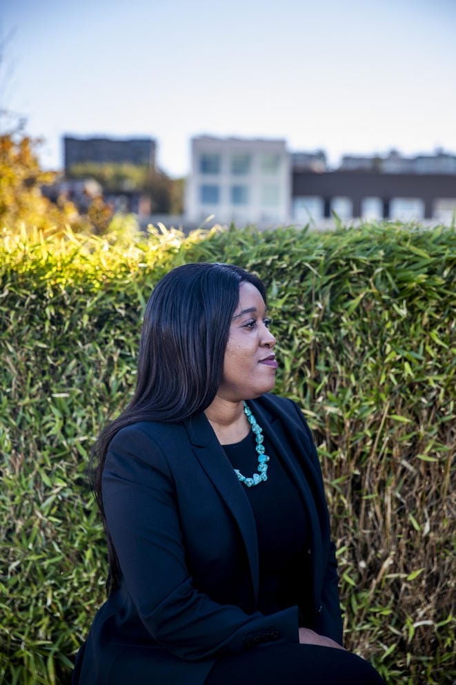 Patience Malaba sits in front of the Seattle skyline.
