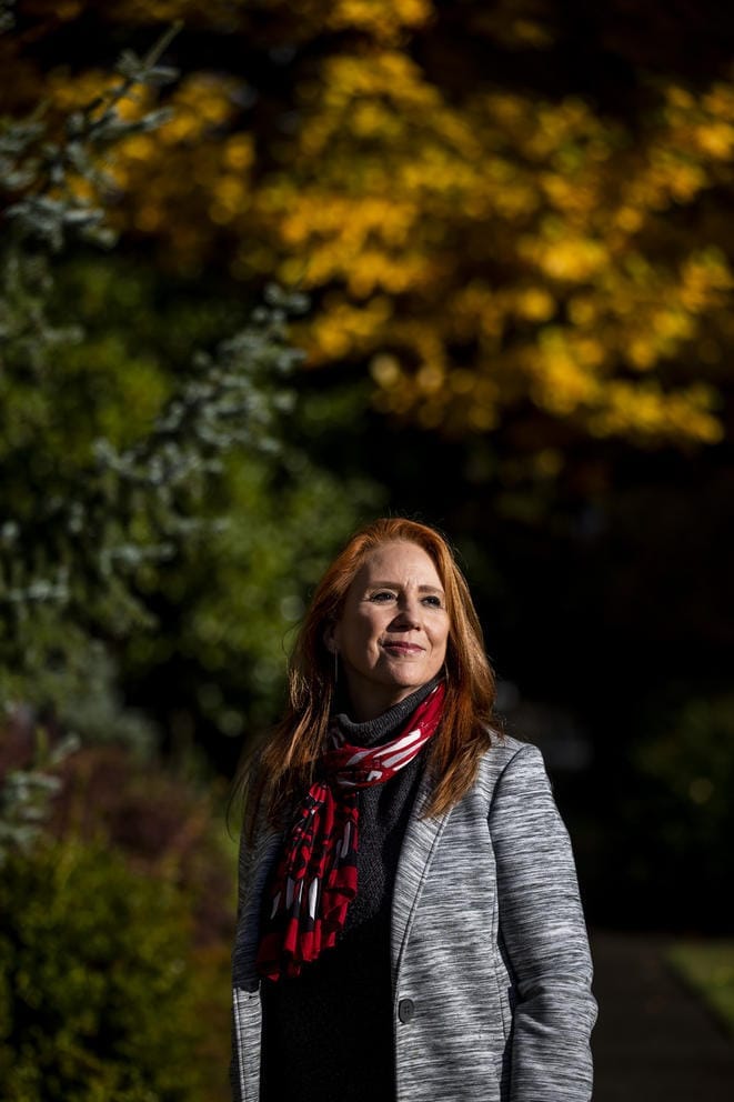 Kim Wyman in front of leaves changing colors