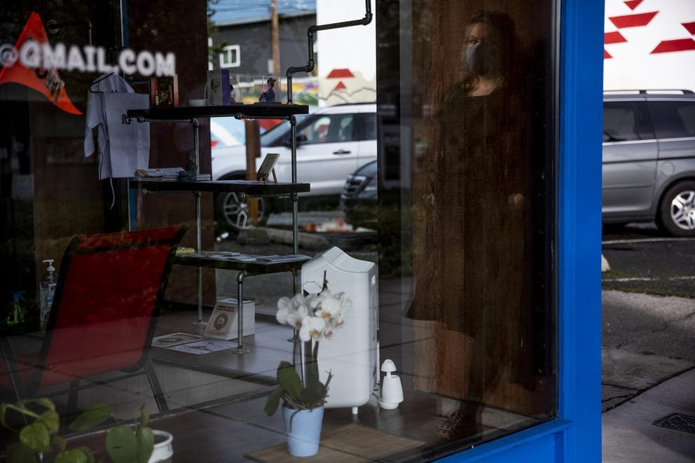 A glass window with a reflection of Sarah Schacht