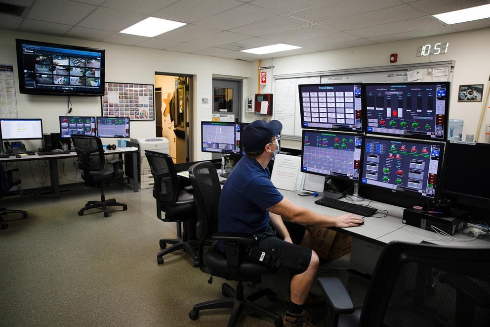 Man looking at computer monitors