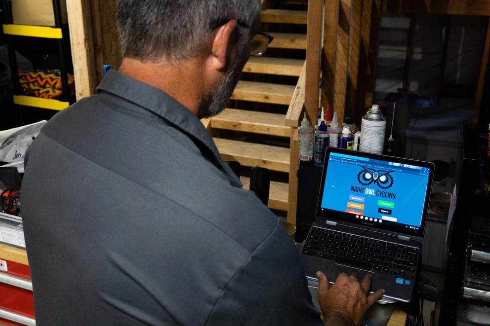 Looking over Kelly Campo's shoulder at a computer screen
